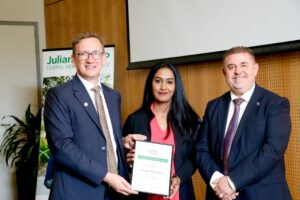 Saranya Balakrishnan with MP Julian Hill and another guy, all smiling.