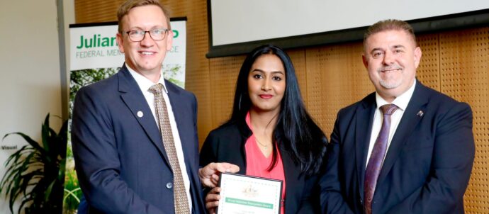 Saranya Balakrishnan with MP Julian Hill and another guy, all smiling.