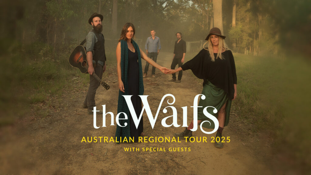 The Waifs tour graphic. White and yellow writing. Photo of the band standing on a dirt road in the bush. The two female members who are sisters are holding hands in the middle of the photo. Another member is to the right holding a guitar.